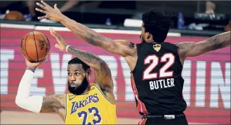  ?? Mark J. Terrill / Associated Press ?? Lebron James of the Lakers narrowly missed a triple-double in Game 1 of the NBA Finals on Wednesday, but Jimmy Butler of the Heat said his team is in the series.