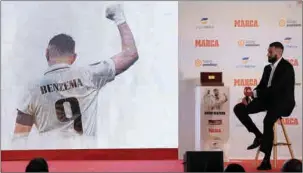  ?? (AFP) ?? Real Madrid’s French forward Karim Benzema watches a video prior to receiving the MARCA Leyenda (MARCA Legend) award in Madrid on Thursday.