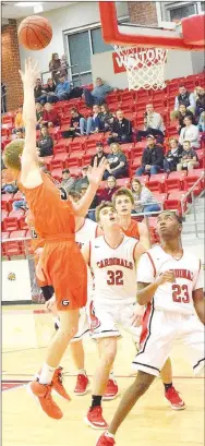  ?? Westside Eagle Observer/MIKE ECKELS ?? Brayden Trembly (Gravette 33, left) puts up a jumper over Cardinals’ William Pridmore (32) and Jayden Whitmore (23) during the third quarter of the Farmington-Gravette game in Farmington Feb. 1. The Lions took the conference win over the Cardinals, 55-44.