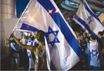  ??  ?? PROTESTERS AT a rally in Tel Aviv. The author argues that protesting at politician­s’ homes is unethical.