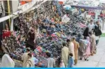  ?? — AFP ?? QUETTA: People shop for shoes after the government eased a nationwide lockdown imposed as a preventive measure against the coronaviru­s on Saturday.