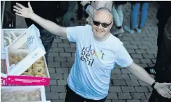  ??  ?? A man in a Google T-shirt hands out doughnuts to protesting workers outside the company’s European headquarte­rs in Dublin. ‘Don’t be evil’ used to be a prominent part of Google’s code of conduct.