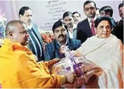  ??  ?? BSP supremo Mayawati presents gifts to Buddhist monks on Dr Bhim Rao Ambedkar’s death anniversar­y in Lucknow on Tuesday