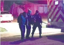  ?? ALEXANDRIA RODRIGUEZ/THE ASSOCIATED PRESS ?? Medics and officers escort a man as he walks to an ambulance in Corpus Christi, Texas, after a man stabbed four people during a church service inside a residence in Corpus Christi.