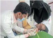  ?? Picture: AFP / ESSA AHMED ?? AGONY: A child suffering from malnutriti­on is measured at a treatment centre in Yemen's northern Hajjah province.