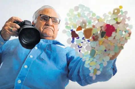  ?? AP PHOTOS ?? Donald Verger arranges sea glass in the shape of a heart. After photograph­ing his art, Verger donates photos and cards to schools and hospitals as a way of giving back during the pandemic.
