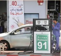  ?? | AP ?? A WORKER refuels a car at a petrol station in Jiddah, Saudi Arabia, on Monday. Global energy prices have spiked after weekend attacks on key oil facilities in Saudi Arabia caused the worst disruption to world supplies on record.