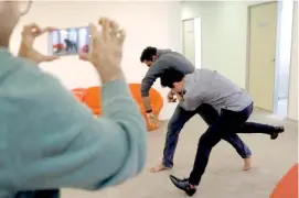  ??  ?? A Graymatics employee show how footage of a pretend fight between co-workers can to be used to 'train' their software to watch and filter internet videos for violence, at their office in Singapore April 27, 2017. REUTERS/Edgar Su