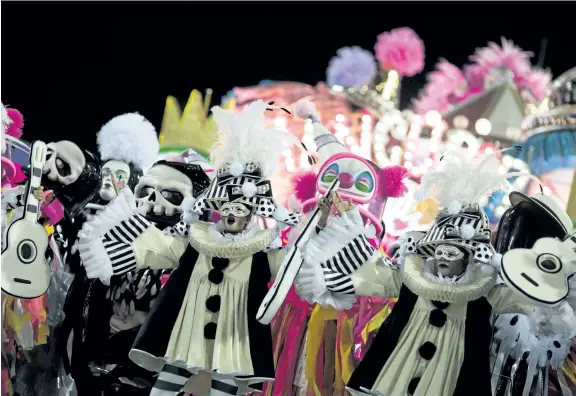  ?? MAURO PIMENTEL/GETTY IMAGES ?? Revellers of the Mangueira samba school perform during Carnival at the Sambadrome in Rio de Janeiro, Brazil. Drag queen Pabllo Vittar will headline the parade of one of Rio de Janeiro’s most storied samba schools, Beija-Flor de Nilopolis samba school.