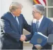  ?? Drew Angerer, Getty Images ?? President Donald Trump shakes hands Thursday with his nominee for the chairman of the Federal Reserve, Jerome Powell.