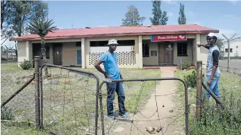  ??  ?? NOT IN USE: Simamkele Dyonase, left, and Andile Nxasana, right, show The Rep the vandalised Ezibeleni Post Office Picture: BHONGO JACOB