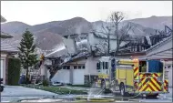  ?? Cory Rubin/The Signal ?? Ventura County firefighte­rs hose down the remains of a house at the end of Sugar Loaf Court in Canyon Country during the Tick Fire Friday morning.