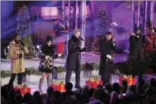  ?? PHOTO BY CHARLES SYKES/INVISION/AP ?? Pentatonix members, from left, Matt Sallee, Kirstin Maldonado, Scott Hoying Mitch Grassi and Kevin Olusola rehearse for the 85th annual Rockefelle­r Center Christmas Tree lighting ceremony on Wednesday, in New York