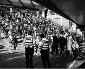  ?? TIM IRELAND/AP ?? A day after Friday’s London subway attack, police observe crowds at Wembley Park Station before a soccer match.