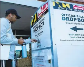  ?? Jose Luis Magana Associated Press ?? A VOTER drops his ballot into a drop box on election day last year in Burtonsvil­le, Md., one of the states seeking to strengthen voting protection­s.