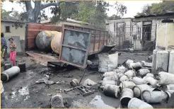 ??  ?? An explosion occurred at an illegal cooking gas operation behind a house on Jacques Avenue, leaving the home and a truck destroyed by fire.