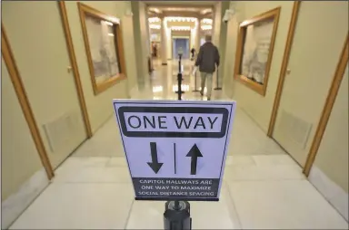  ?? (Arkansas Democrat-Gazette/Staton Breidentha­l) ?? Signs in the hallways of the state Capitol inform visitors of social distancing rules. Arkansas’ 93rd General Assembly begins at noon Monday while coronaviru­s cases continue to soar.