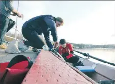  ?? — File photo by Gary Hebbard/the Telegram ?? The Roebothan McKay Marshall women’s crew prepares to take the Lambs Palm Breeze shell for a practice spin on Quidi Vidi Lake earlier this year. Weather permitting, the 195th running of the Royal St. John’s Regatta will take place Wednesday.