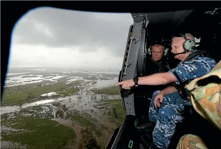  ?? PHOTO: FAIRFAX ?? Australian Chief of the Defence Force Air Marshal Mark Binskin with Labor leder Bill Shorten look at the damage below from an army helicopter. Prime Minister Malcolm Turnbull and Shorten visited the cyclone damaged area of Bowen in north Queensland...
