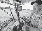  ??  ?? Bob Roden runs his combine in West Bend, Wis. Wet weather is “another nail in the coffin” for some farms, he says.