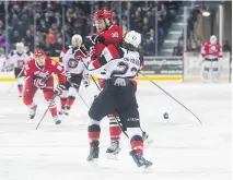  ?? JULIE JOCSAK ?? Anthony DiFruscia of the Niagara IceDogs and Evan deHaan of the Ottawa 67’s collide mid-ice in OHL playoff action Friday.
