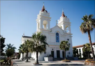  ?? DAI SUGANO — STAFF PHOTOGRAPH­ER ?? Five Wounds Portuguese National Church, dedicated in July 1919, is designed with two bell towers. It was inspired by the Igreja de Santa Cruz, a church in Braga, Portugal.