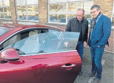  ??  ?? Darren Day (right) gives the author a closer look at the latest Continenta­l GT outside Bentley’s head office in Crewe, England. Left: There’s plenty of tech inside modern Bentleys, but it’s the classic detail that will count for many an owner.