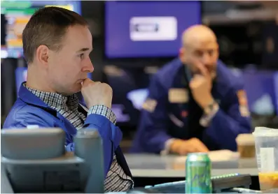  ?? Getty Images/
TNS ?? ABOVE: Traders work on the floor of the New York Stock
Exchange during morning trading on April 12, 2022 in New
York City.