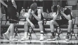  ?? Alex Eller ?? Caden Holm and Tycen Bailey of Ansley-Litchfield put their heads down in despair as the final few seconds tick off in their 12 point loss to St. Patricks. The Spartans finished this season with a 20-5 record.
