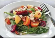  ?? CONTRIBUTE­D BY CHRIS HUNT PHOTOGRAPH­Y ?? Roasted Beet Salad is made with roasted beets, praline pecans, poached apples, goat cheese, spinach, and citrus beet vinaigrett­e.