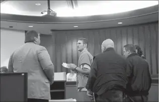  ?? Staff photo by evan Lewis ?? Tucker Strickland confers with his defense lawyer, Chief Public Defender Rick Shumaker, as he is led from a second-floor courtroom following a pretrial hearing Thursday at Bowie County Courthouse in New Boston, Texas. Strickland is accused of fatally...