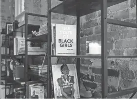  ?? COLUMBUS DISPATCH PHOTOS BY BARBARA J. PERENIC/ ?? A bookcase at GRND holds works of fiction and nonfiction by Black authors, who tell the stories of Black characters and personalit­ies.