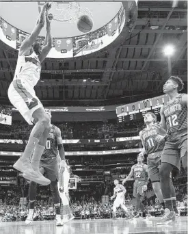  ?? NICK WASS/AP ?? Wizards center Ian Mahinmi dunks during the second half Friday in Washington.