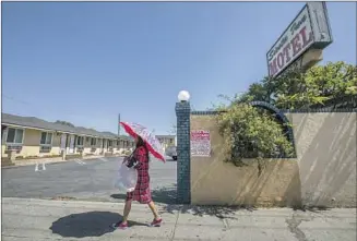  ?? Photograph­s by Francine Orr Los Angeles Times ?? TWO POLICE OFFICERS were fatally shot June 14 outside El Monte’s Siesta Inn after responding to a call. El Monte prides itself on having officers who grew up in the city and still live there.