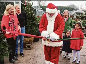  ?? Ken Borsuk / Hearst Connecticu­t Media ?? Santa is joined by, from left, event organizer Tamara Ketler, sponsor Jenny Allen from Compass, and Sam Bridge to kick off the annual Reindeer Festival.