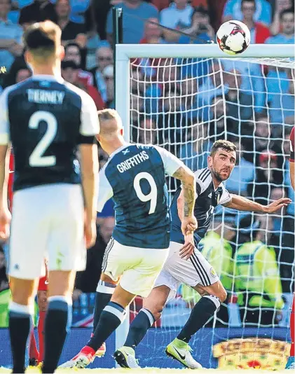  ??  ?? Leigh Griffiths curls the ball past the England wall and keeper Joe Hart for his quite stunning equaliser