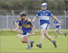  ??  ?? Carnew’s Timmy Collins looks to shake free of the shackles of Barndarrig’s Michael Cullen.