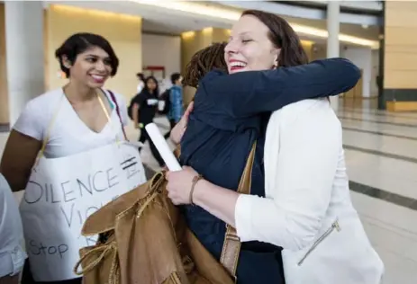  ?? CARLOS OSORIO/TORONTO STAR ?? Mandi Gray, right, hugs supporter Ellie Adekur after going public with her complaint against York University at the Human Rights Tribunal of Ontario.