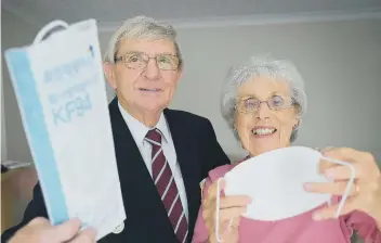  ??  ?? Ken Keld and his wife Hazel with their masks sent from South Korea. 201931dKen is also pictured at bottom of page.