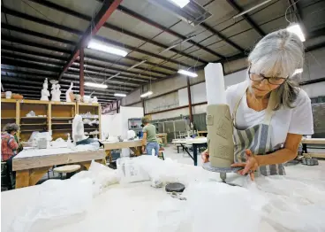  ?? PHOTOS BY LUIS SÁNCHEZ SATURNO/THE NEW MEXICAN ?? Michele English of Santa Fe works on a vase recently at Santa Fe Clay. After about 45 years in the Santa Fe Railyard, the current owners plan to move the business to a site north of Santa Fe.