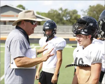  ?? PHOTOS BY DWAIN HEBDA/CONTRIBUTI­NG PHOTOGRAPH­ER ?? Head coach Dave King gives some pointers to senior back Jack Lanier and other members of the Pioneers’ D-line during a summer workout.