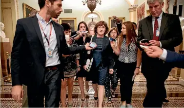  ?? AP ?? Senator Susan Collins, R-Maine, a key Republican vote on any eventual Senate decision on Judge Brett Kavanaugh’s nomination for a Supreme Court chair, is surrounded by reporters asking her questions.