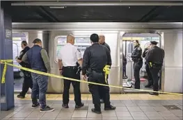  ?? Paul Martinka New York Post ?? NEW YORK police officers investigat­e the subway car where Jordan Neely died. Daniel Penny, who put Neely in a chokehold, is expected to turn himself in Friday.