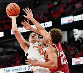  ?? Adrian Kraus / Associated Press ?? Syracuse forward Jimmy Boeheim (0) shoots over Indiana forward Race Thompson on Tuesday night. Boeheim had a career-high 26 points.