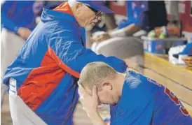  ?? | AP ?? Joe Maddon tries to console Trevor Cahill after the Cubs reliever gave up a three-run homer to Adam Duvall and a solo shot to Scott Schebler in the sixth inning.