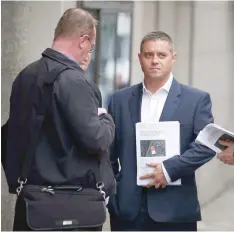  ?? — AFP ?? Former British actor John Alford (R), who was jailed in a sting arranged by Mazher Mahmood, a British journalist known as the Fake Sheikh stands outside the Old Bailey Central Criminal Court in central London, on Friday.