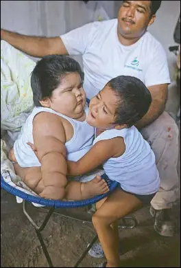  ?? AFP ?? Mario Gonzales looks as his older son Mario hugs his 10-monthold brother Luis Manuel at their home in Tecoman, Mexico.