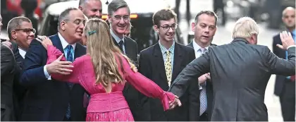  ?? ?? Time to go: Boris drags Carrie away from supporters towards a waiting armoured Range Rover