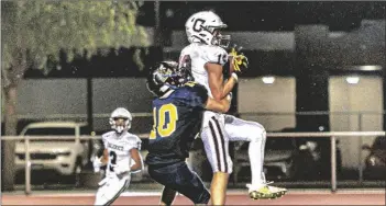  ?? PHOTO VINCENT OSUNA ?? Calexico High’s Andrew Rivera (right) secures a pass against Calipatria High’s Rafa Velasco during the team’s game against Calipatria on Friday in Calipatria.