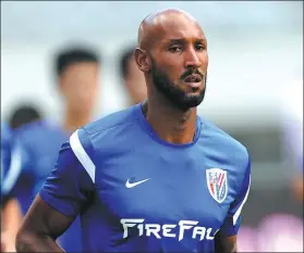  ?? AFP ?? Nicolas Anelka trains with Shanghai Shenhua in 2012. In June of that year, the Frenchman was joined at the Chinese Super League club by former Chelsea teammate Didier Drogba — pictured signing autographs at Pudong Internatio­nal Airport. The pair are regarded as the first major soccer superstars to ply their trade in China, however both ultimately ended their CSL careers in controvers­y following pay and boardroom disputes and a falling-out with fans.